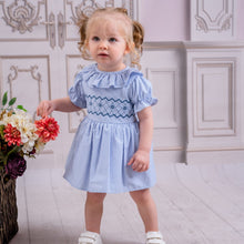 Load image into Gallery viewer, Spanish style smocked dress for little girls in a pale blue and white colourway with smocked detailing to the middle and frilly collar and gathered frill puff sleeves. A stunning piece for any special occasion