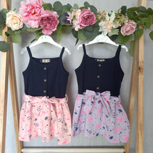 Load image into Gallery viewer, Girls strappy summer dress with pink or lilac skirts covered in a summery flamingo and palm tree print with pops of neon pink throughout giving it all the summer vibes
