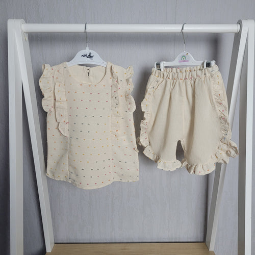 Luxury high end brand, gorgeous two piece shorts and blouse set for little girls, adorable frill detailing to both pieces, gorgeous cream colour with pastel polka dot design, a real showstopper. Stunning outfit for baby girl