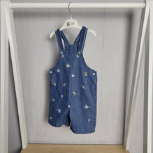 Load image into Gallery viewer, Dark denim floral dungarees for baby girl, gorgeous embroidered floral design all over the front, adjuatable straps for longer wear, light airy material perfect for summer holidays, wear as is or pair with a t-shirt or long sleeved top

